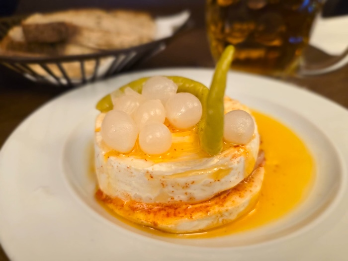 Nakládaný hermelín – Marinated Camembert-like cheese, served with bread and pickles.